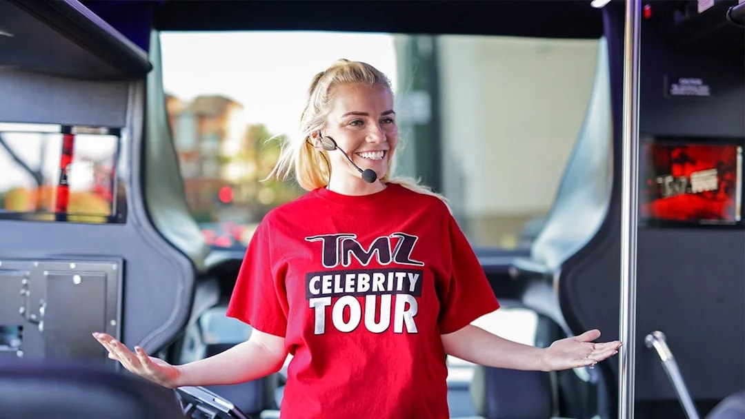 Tour guide on TMZ Hollywood Tour bus with microphone.
