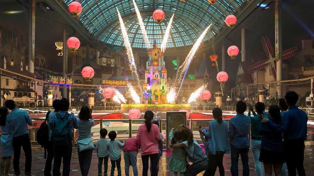 Fireworks display at Lotte World with a crowd watching inside the theme park.