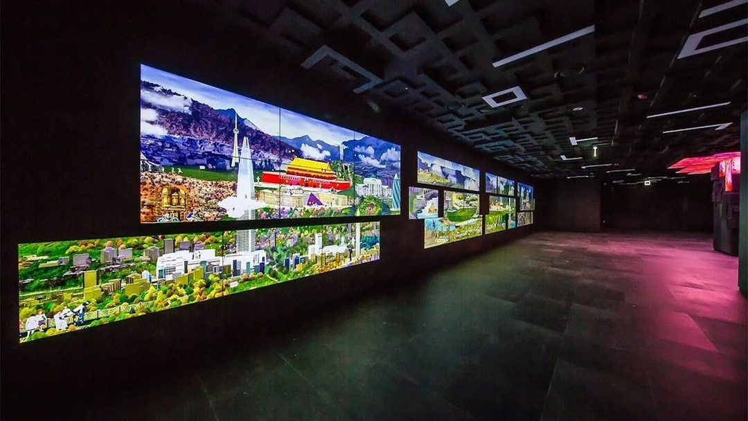 Digital displays at Lotte World Tower Seoul Sky showing cityscapes and landmarks.