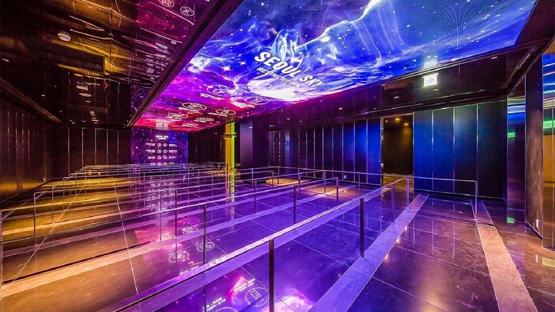 Queue area with illuminated ceiling at Lotte World Tower Seoul Sky.