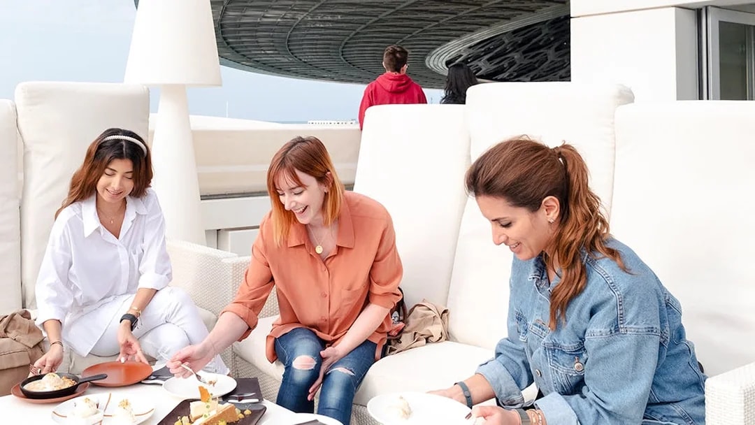 Guests dining at the cafe in Louvre Museum Abu Dhabi.