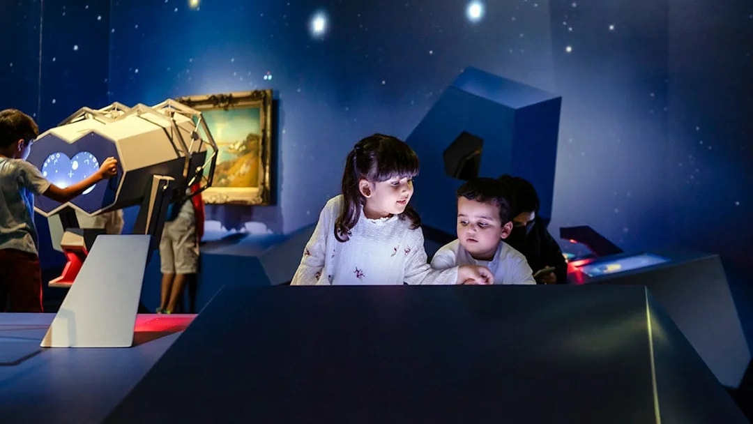 Children exploring interactive exhibits at Louvre Abu Dhabi.