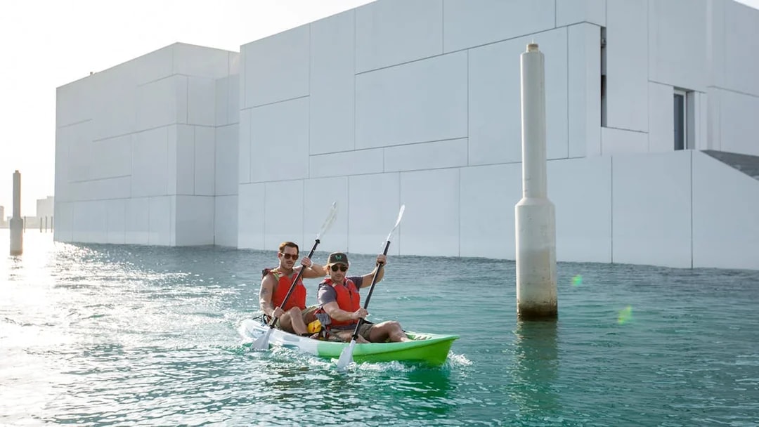 Kayakers paddling near Louvre Abu Dhabi on a guided tour.