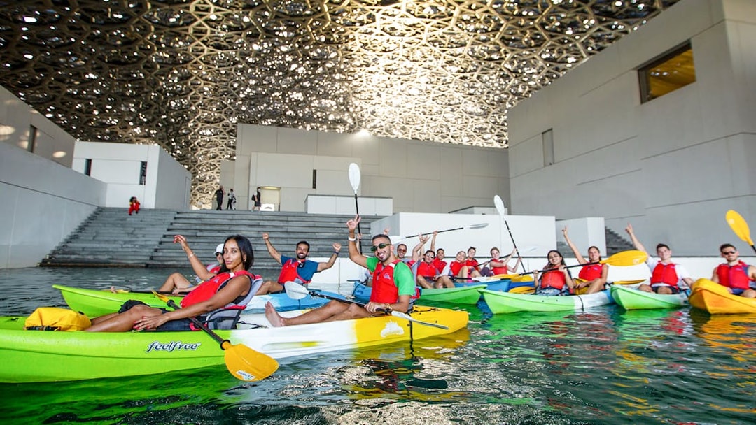 Tourists kayaking under the dome of Louvre Abu Dhabi.