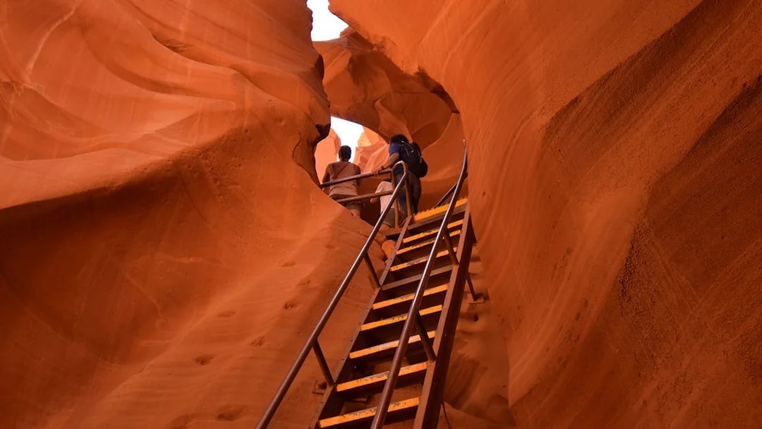 Tourists ascending stairs in Lower Antelope Canyon with Ken's Tours.