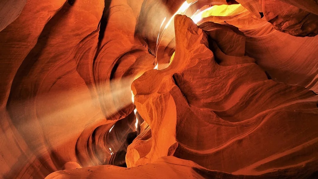 Sunlight streaming through the narrow sandstone walls of Lower Antelope Canyon.