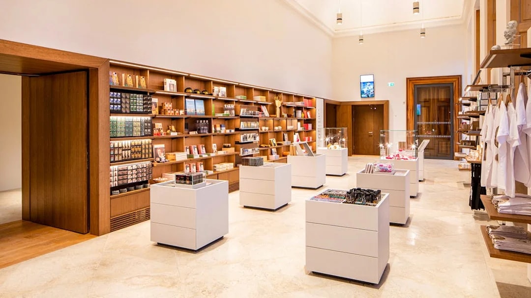 Gift shop inside Belvedere Palace with shelves of souvenirs and display cases.