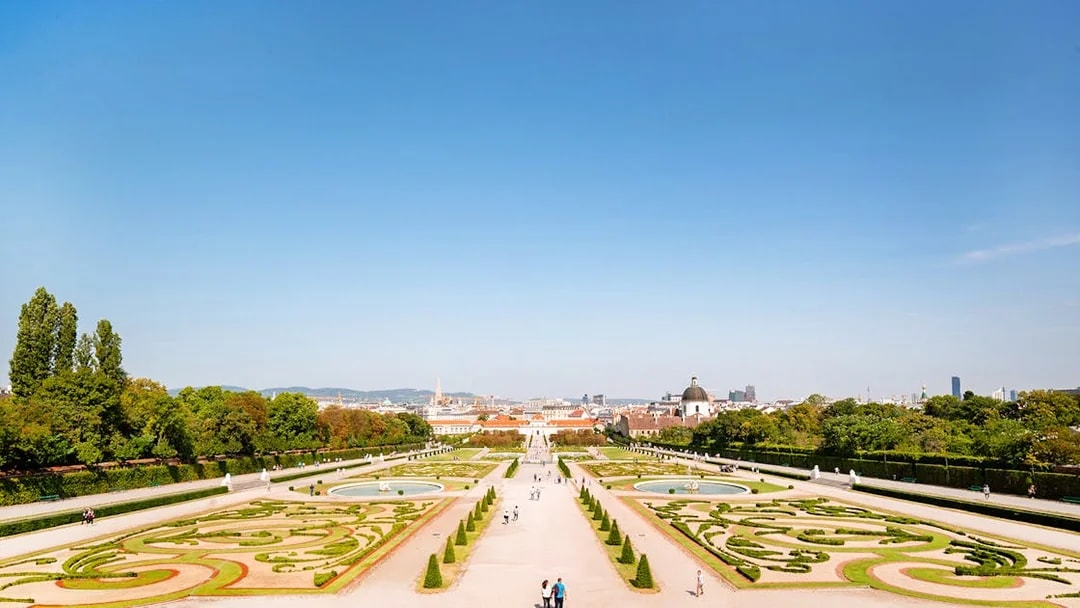 Lower Belvedere Palace gardens in Vienna with city skyline in the background.