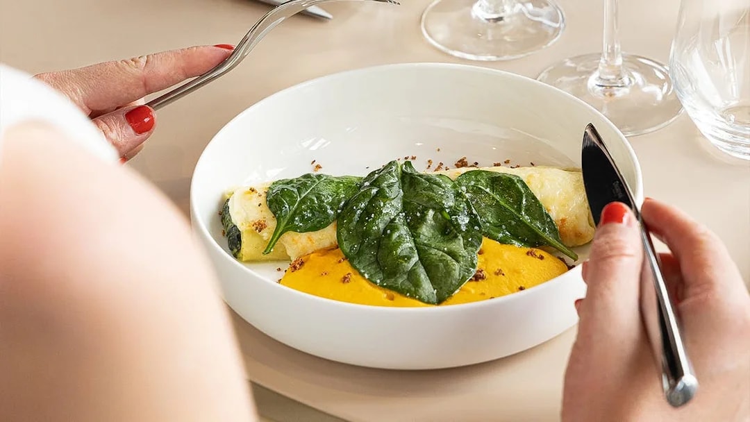 Lunch dish with spinach and sauce at Eiffel Tower's Madame Brasserie, Paris.