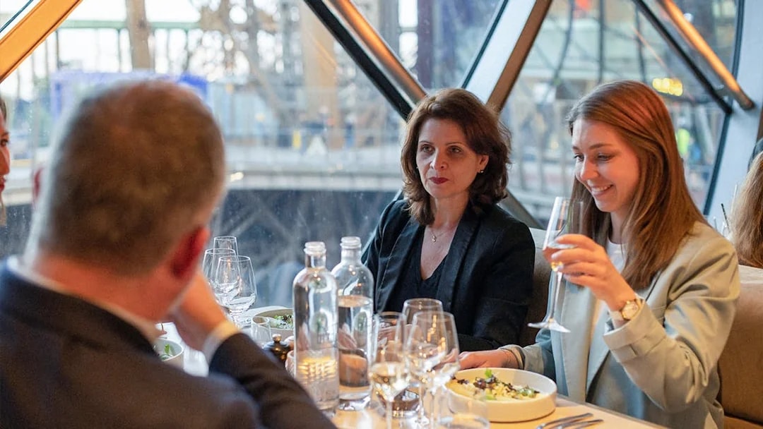 Lunch at Madame Brasserie, Eiffel Tower, with diners enjoying a meal and drinks.