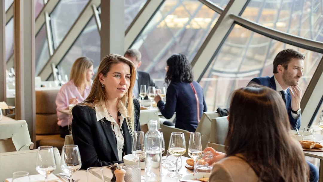 Lunch at Madame Brasserie, Eiffel Tower, with diners enjoying a meal and view.