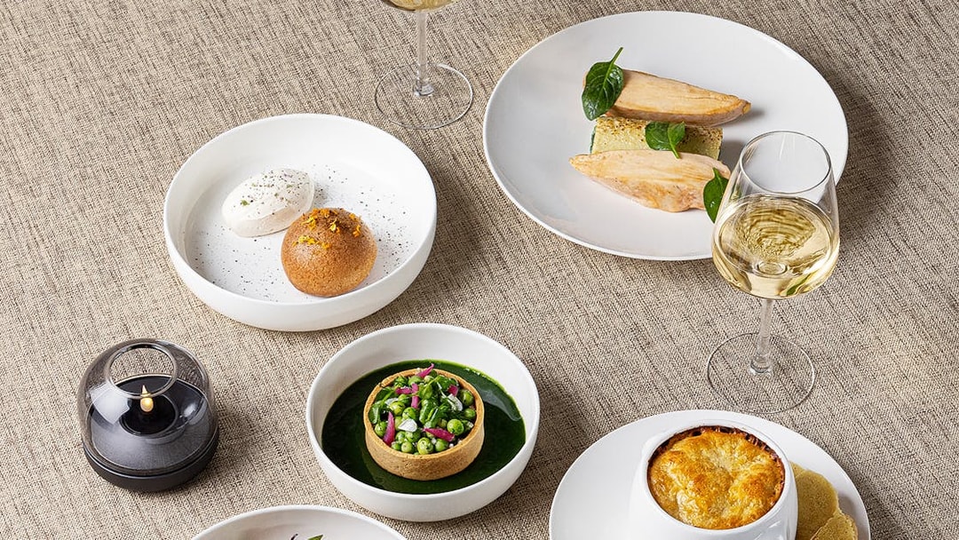 Lunch dishes at Madame Brasserie, Eiffel Tower, featuring gourmet plates and wine.