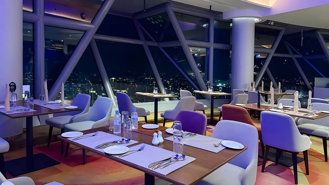 Dining area with city view at Orbit Revolving Restaurant, KL Tower, Kuala Lumpur.