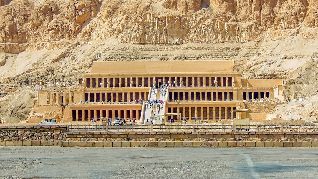 Luxor Temple entrance with tourists, showcasing ancient Egyptian architecture.