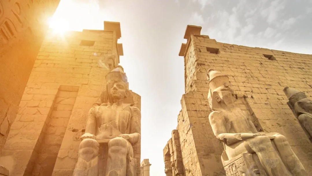 Luxor Temple statues and ancient walls under sunlight, Egypt.