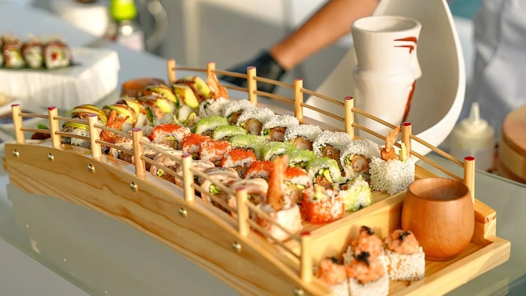 Sushi platter on Sunseeker superyacht with gourmet dining setup.