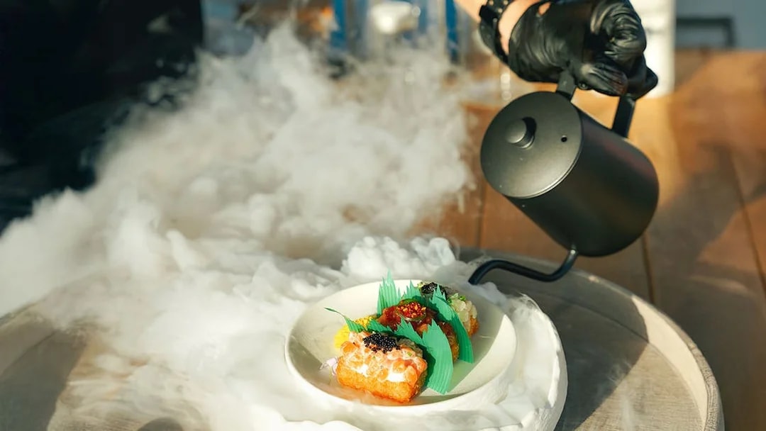 Gourmet dish with smoke effect on Sunseeker Superyacht dining experience.