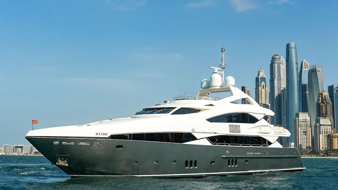 Superyacht cruising near Dubai skyline, offering gourmet dining and live music experience.