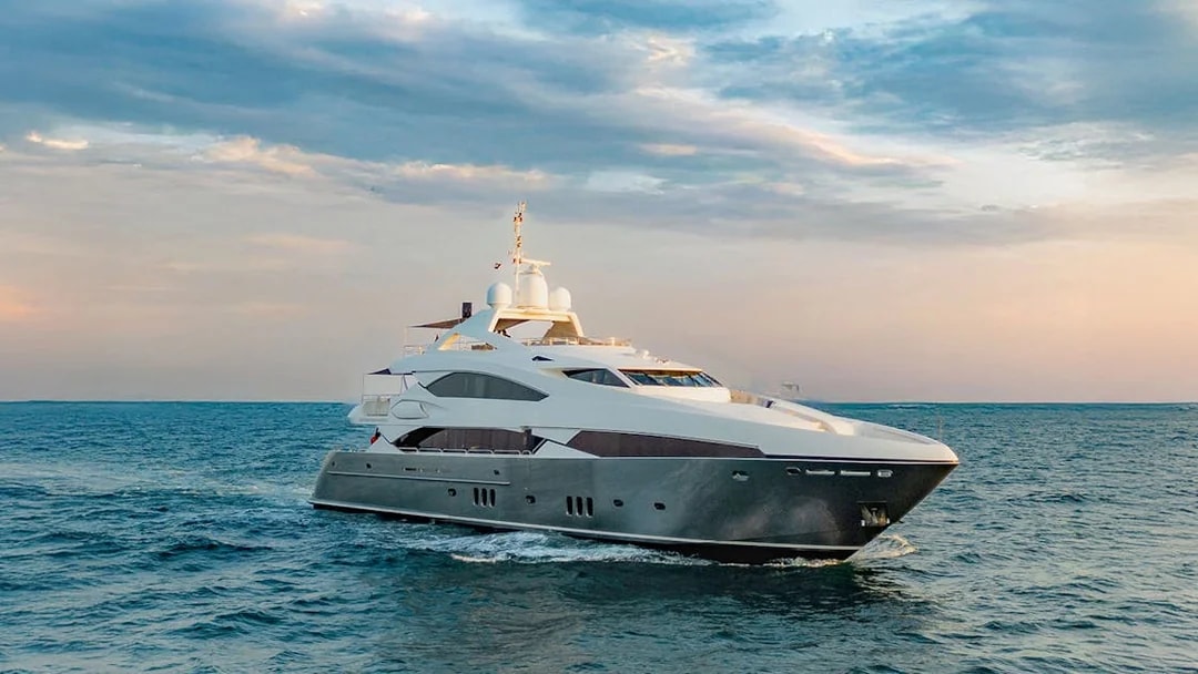 Sunseeker superyacht cruising at sunset, offering gourmet dining and live music experience.