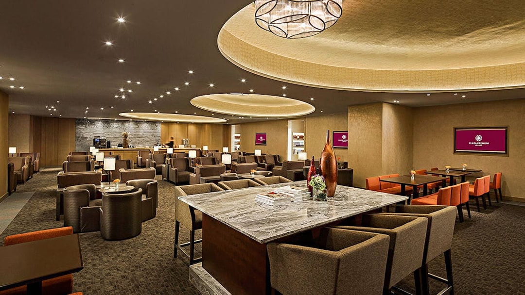 Plaza Premium Lounge interior with seating and dining areas.