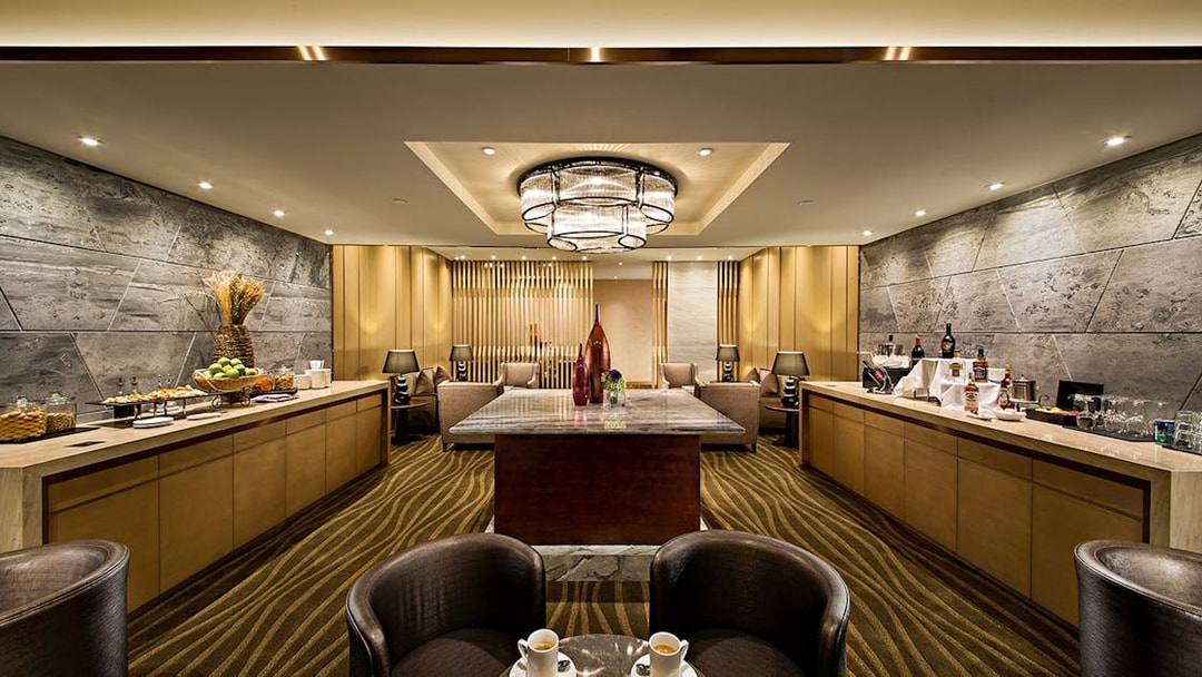 Plaza Premium Lounge interior with seating, refreshments, and modern decor.