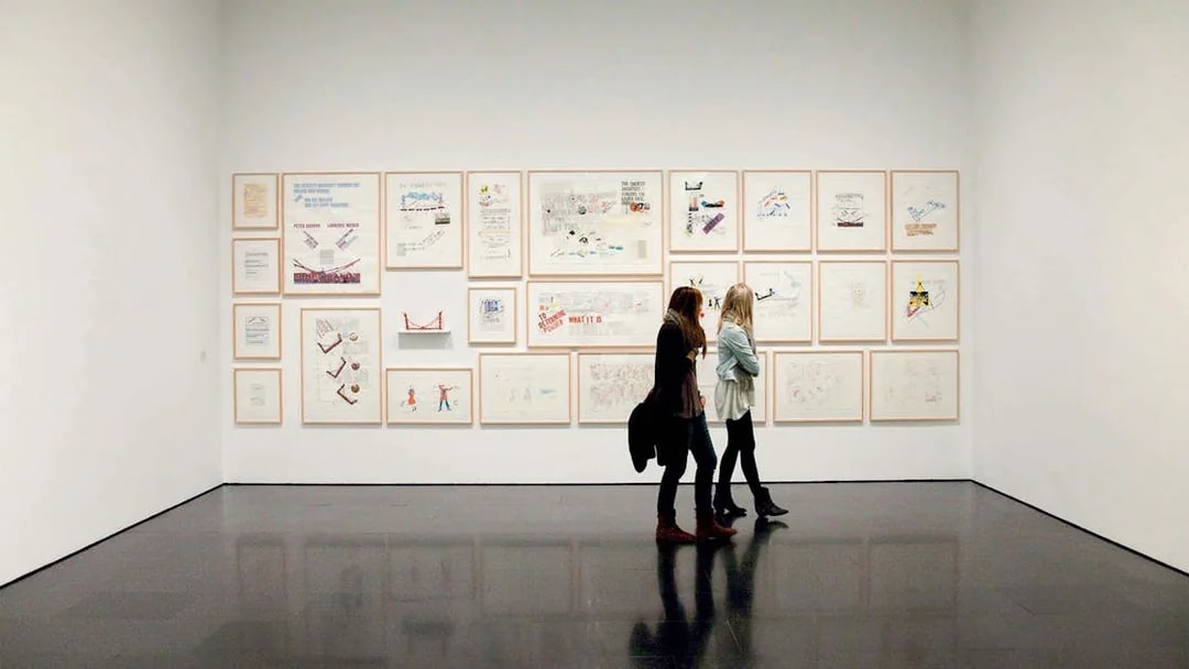 Visitors viewing framed artworks at the Museum of Contemporary Art of Barcelona (MACBA).