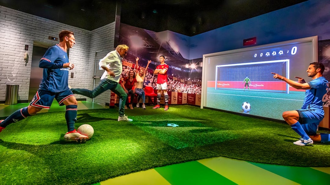 Penalty kick experience at Madame Tussauds Dubai with interactive soccer display.