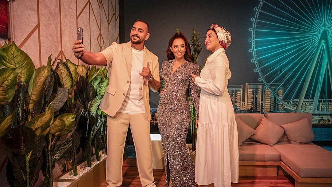 Balqees Fathi wax figure with visitors at Madame Tussauds Dubai, near Dubai Eye.