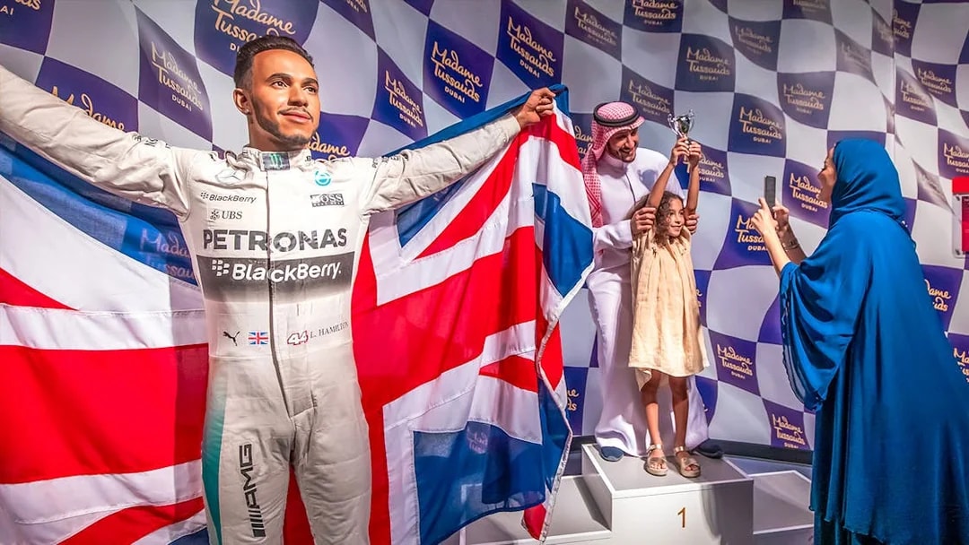 Lewis Hamilton wax figure with British flag at Madame Tussauds Dubai.