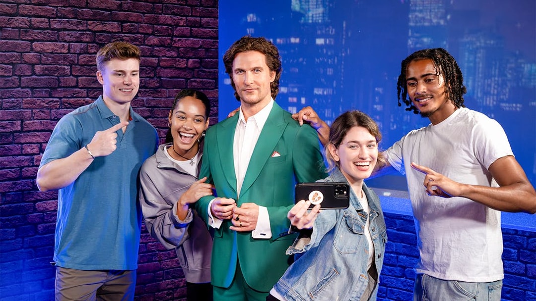 Friends posing with wax figure at Madame Tussauds, New York.