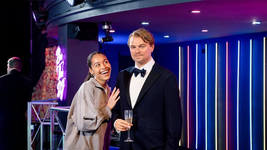 Girl posing with Leonardo DiCaprio wax figure at Madame Tussauds, New York.