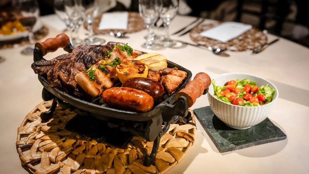 Grilled meats and salad served at Madero Tango Show in Buenos Aires.
