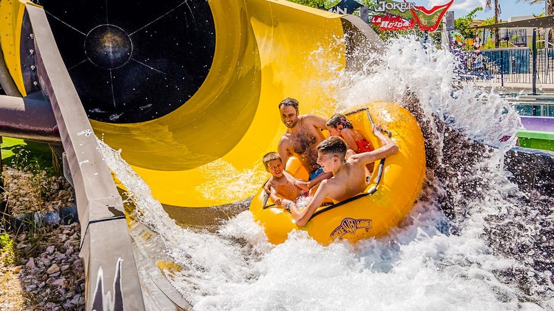Group enjoying water slide at Parque Warner Beach, Madrid.