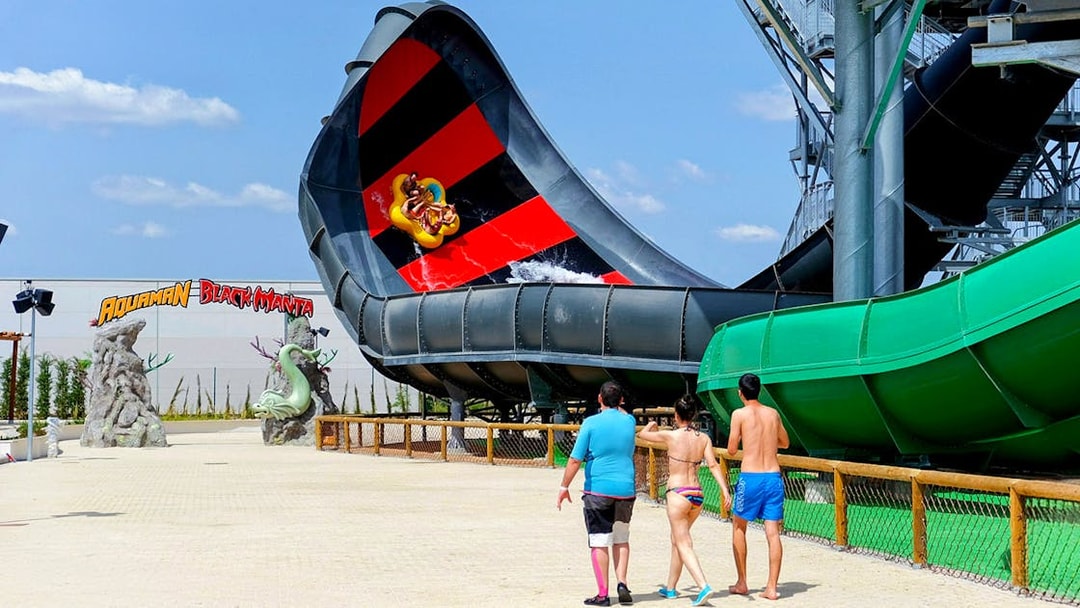 Visitors approach Aquaman Black Manta water slide at Parque Warner, Madrid.