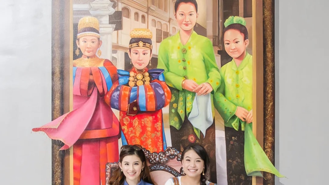 Two visitors pose in front of a 3D mural at Magic Art 3D Museum.
