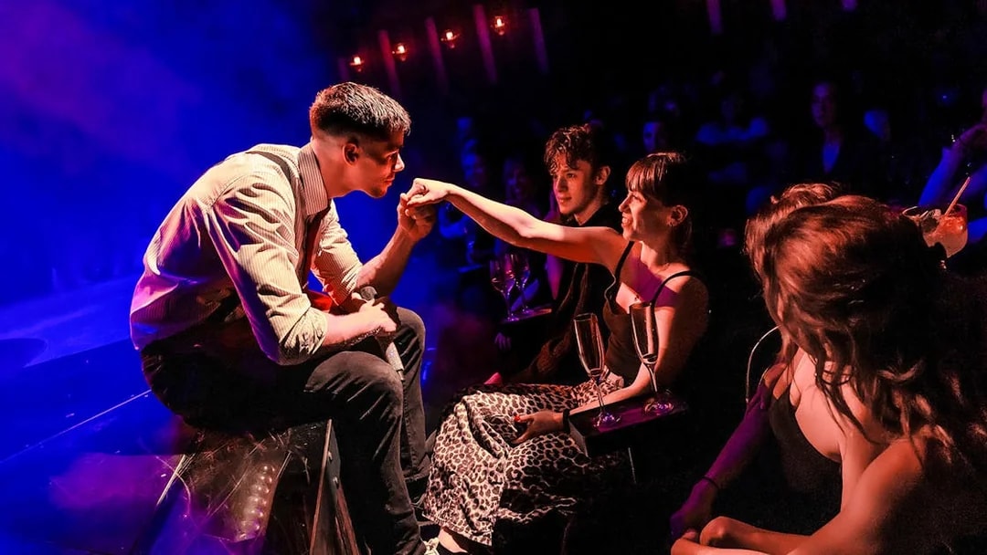 Performer interacting with audience at Magic Mike Live show.