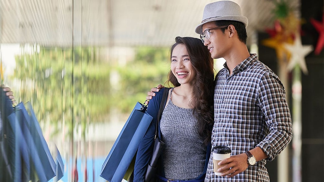 Couple shopping near Maha Tower, Malaysia.
