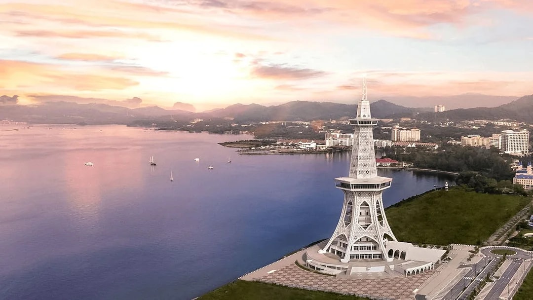 Maha Tower overlooking the waterfront in Malaysia at sunset.