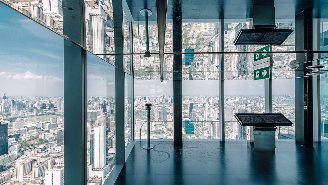 Bangkok cityscape view from Mahanakhon SkyWalk observation deck with glass floor.