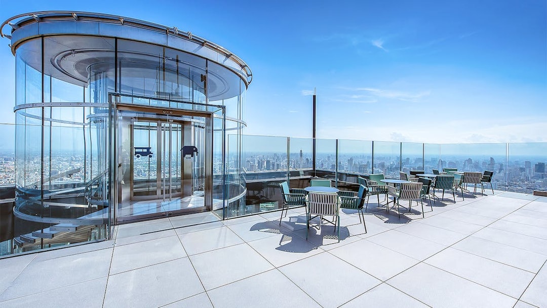 Mahanakhon SkyWalk glass elevator and observation deck with city view in Bangkok, Thailand.