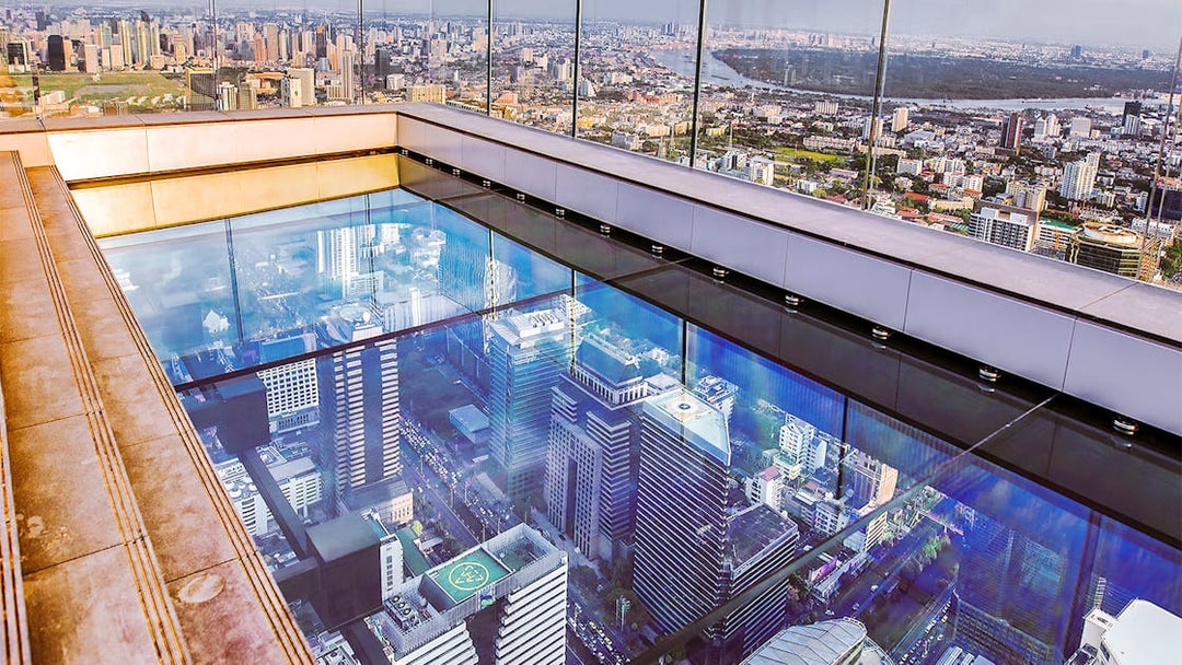 Mahanakhon SkyWalk glass floor with Bangkok cityscape view, Thailand.