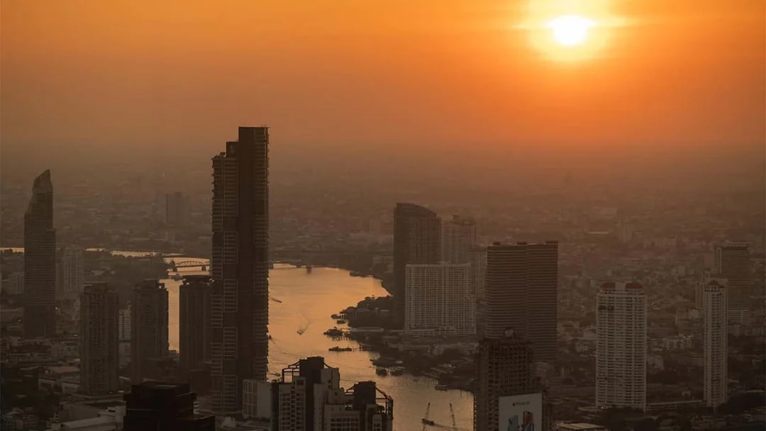 Bangkok skyline view from Mahanakhon SkyWalk at sunset.