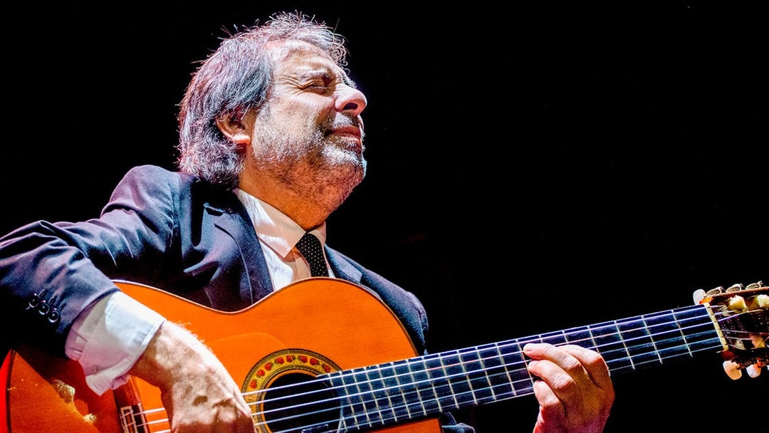 Flamenco guitarist performing at Esencia espectáculo flamenco.