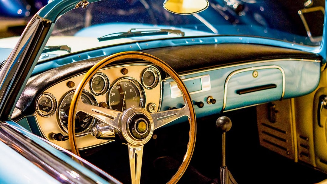 Classic car dashboard and steering wheel at Malta Classic Car Collection Museum.