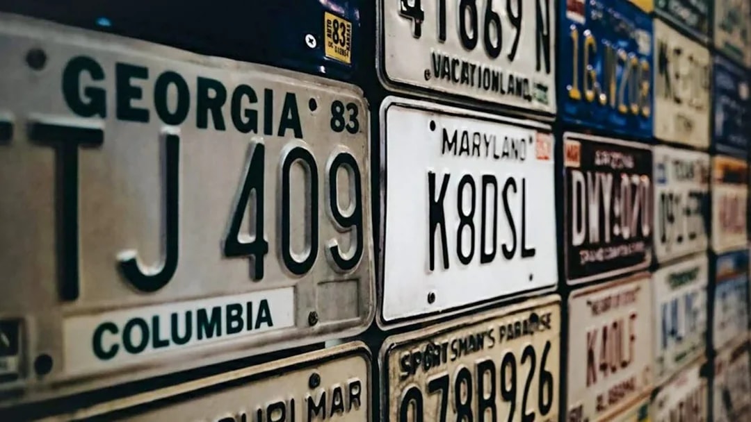 Vintage license plates display at Malta Classic Car Collection Museum.