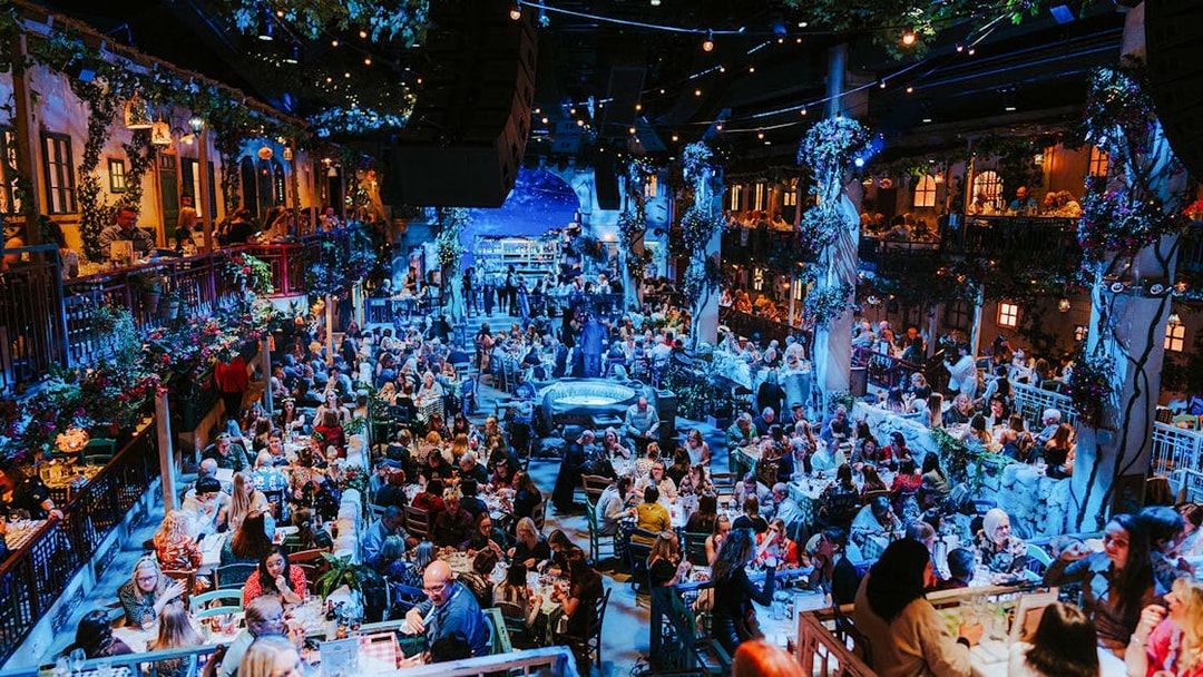 Crowd enjoying dinner and entertainment at Mamma Mia! The Party venue.