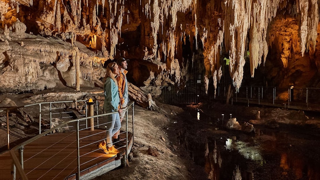 Visitors exploring stalactites in Mammoth Cave, Margaret River on a self-guided audio tour.