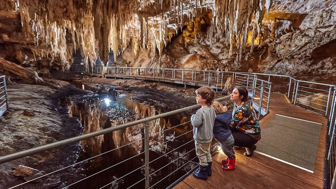 Family exploring Mammoth Cave on a self-guided audio tour in Margaret River.