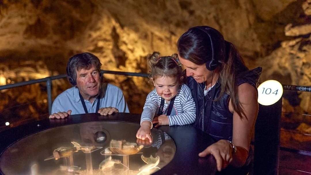 Family exploring Mammoth Cave exhibit on self-guided audio tour, Margaret River.