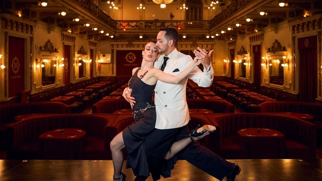 Dancers performing tango on stage at Mansión Tango Show venue.
